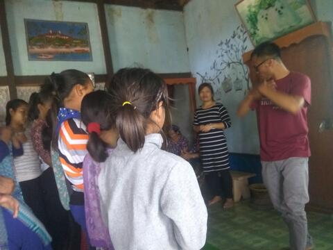 Mr. Kamminthang (the Preacher) teaching action song to the children